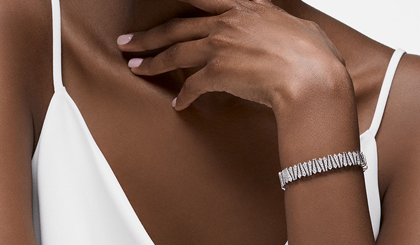 A woman wearing a Birks Beekeeper diamond bangle bracelet.